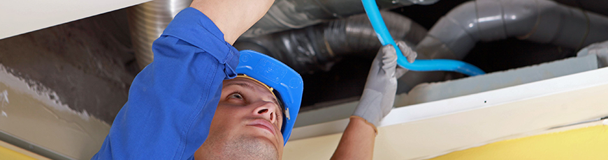 Technician working on ductwork